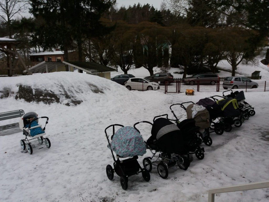 Perhekerhon kokoontuminen, lastenvaunut rivissä.