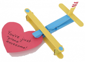 Clothespin airplane with heart shaped message attached.